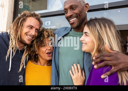 A candid moment among a group of four diverse and happy friends Stock Photo