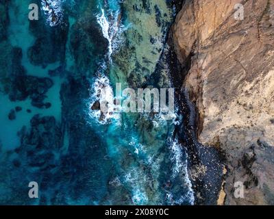 Aerial view of the rugged coastline with turquoise waters, rocky cliffs ...