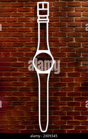 wrist watch lamp logo design illuminated on neon light decorated on bricks wall at retro old school design Stock Photo