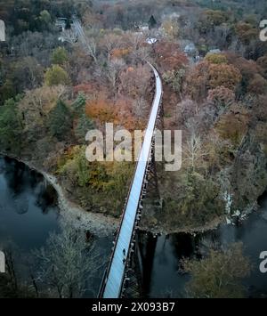 view of rosendale trestle passing over rondout creek at dusk (sunset, low light) old railroad bridge converted to bike, pedestrian path (cycling, biki Stock Photo