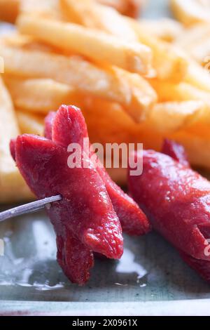 A plate of sausages and fries a delicious meat dish Stock Photo