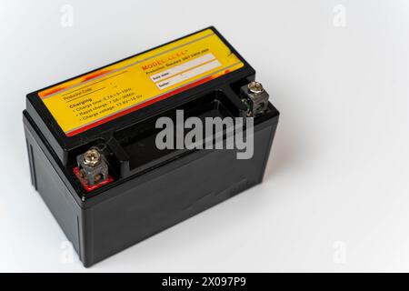 A single compact battery designed for use in a moped or motorcycle, shown in a close-up on a clean white background with plenty of space for text or a Stock Photo