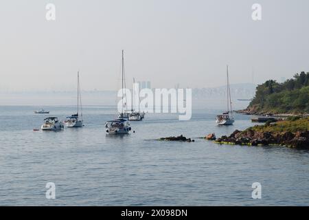 Drifting yachts with lowered sails in the Princes' Islands in the Sea of Marmara. Stock Photo
