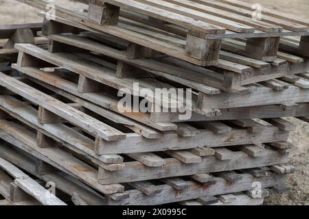 Background of old wooden pallets stacked on top of each other in outdoor environment. Close up Stock Photo