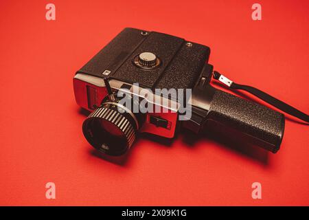 vintage portable movie camera on a red background. retro, 70s, 80s. Stock Photo