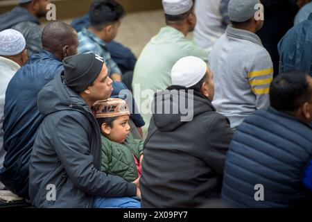 April 10, 2024, Rome, Italy: A Muslim man and his son listen to the Imam's words on Eid al-Fitr to celebrate the end of the month of Ramadan in Rome. According to the Union of Islamic Communities of Italy (UCOII) over 2.6 million Muslims in Italy celebrate the end of the month of Ramadan on Eid al-Fitr. In Islamic culture, Ê¿Ä«d al-fiá¹-r (literally: feast of breaking the fast), is the holiday that marks the end of the lunar month of Ramaá¸Än and therefore the end of religious fasting. It is the second most important Islamic holiday after the ''feast of sacrifice'', celebrated in the month o Stock Photo