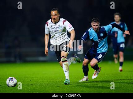 Derby County's Kane Wilson (left) and Wycombe Wanderers' Matt Butcher battle for the ball during the Sky Bet League One match at Adams Park, Wycombe. Picture date: Wednesday April 10, 2024. Stock Photo