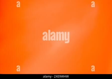 Vibrant, monochromatic, orange and yellow background. Saturated, warm colored acrylics on paper. Close up photo of hand painted abstract painting. Stock Photo