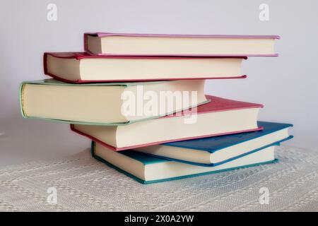 Hardback Books Stacked on White Background, 2024, Stock Photo