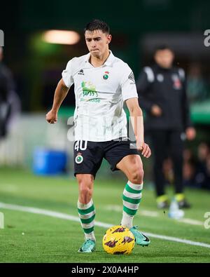 Mario Garcia of Real Racing Club compete for the ball with