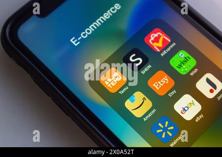 Icons of Temu, Shein, AliExpress, Amazon, Etsy, Wish.com, Walmart, eBay and Joom seen in an iPhone screen. Popular e-commerce concept image. Stock Photo