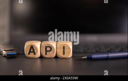 three wooden cubes with letters API Stock Photo