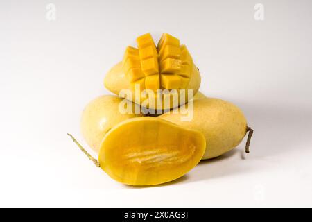 Mango fruits and mango cubes isolated on white background Stock Photo