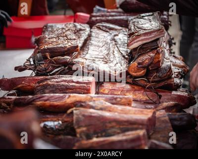 Picture of serbian bacon and other smoked meat products, as well as cured meat, for sale in a market of Serbia in Kacarevo. Stock Photo