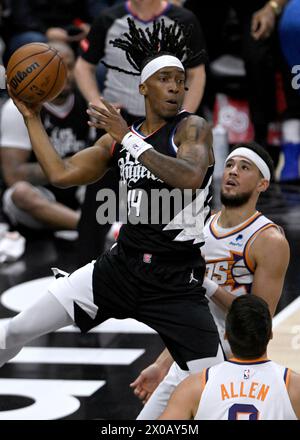 Los Angeles, United States. 10th Apr, 2024. Los Angeles Clippers guard Terance Mann (14) passes the ball away from Phoenix Suns guard Devin Booker (R) during the first half at Crypto.com Arena in Los Angeles on Wednesday, April 10, 2024. Photo by Alex Gallardo/UPI Credit: UPI/Alamy Live News Stock Photo