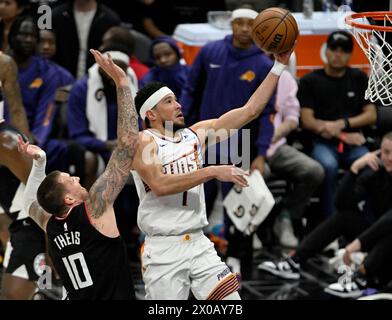 Los Angeles, United States. 10th Apr, 2024. Phoenix Suns guard Devin Booker (1) shoots past Los Angeles Clippers center Daniel Theis (10) during the first half at Crypto.com Arena in Los Angeles on Wednesday, April 10, 2024. Photo by Alex Gallardo/UPI Credit: UPI/Alamy Live News Stock Photo