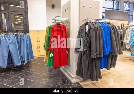 autumn coats in a clothing store hanging on hangers Stock Photo