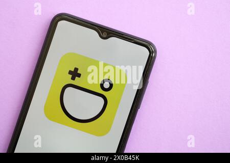 KYIV, UKRAINE - APRIL 1, 2024 Hago icon on smartphone screen on purple table close up. iPhone display with app logo on lilac background Stock Photo