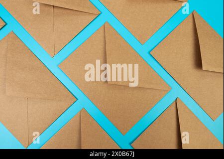 Top view of brown kraft envelopes on blue background. Post flat lay. Copy space. Stock Photo