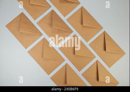 Top view of kraft brown envelopes on grey background. Post flat lay. Copy space. Stock Photo