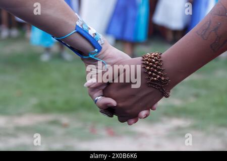 women from Maracatu, a Brazilian cultural and religious artistic activity, holding hands in a gesture of peace, celebration, respect and friendship Stock Photo