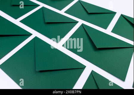Top view of green envelopes on white background. Post flat lay. Copy space. Stock Photo