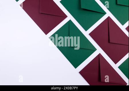 Top view of green and red envelopes on white background. Post flat lay. Copy space. Stock Photo