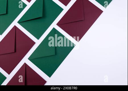 Top view of green and red envelopes on white background. Post flat lay. Copy space. Stock Photo