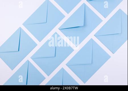Top view of light blue envelopes on white background. Post flat lay. Copy space. Stock Photo