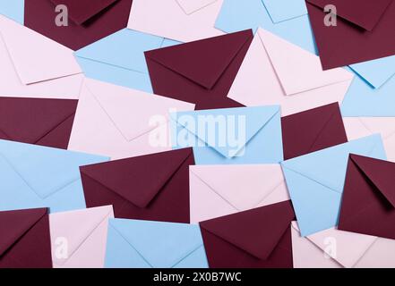 Top view of colourful envelopes. Pink, blue and dark red envelopes flat lay. Copy space. Stock Photo
