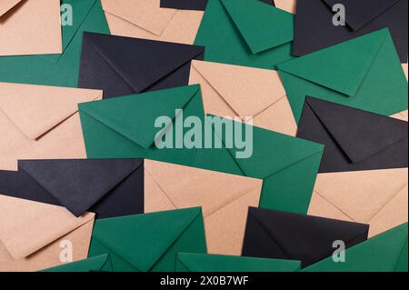 Top view of colourful envelopes. Black, green and kraft brown envelopes flat lay. Copy space. Stock Photo