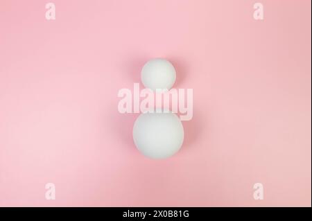 Top view of two white balls on pink background. Geometric abstract shapes for cosmetic product presentation. Flat lay, copy space. Stock Photo