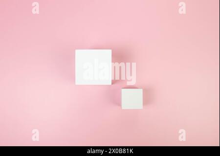 Top view of two white square podiums on pink background. Geometric abstract shapes for cosmetic product presentation. Flat lay, copy space. Stock Photo