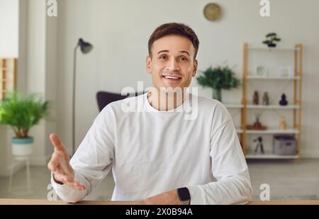 Young man working and chatting online or having video conference call on laptop. Stock Photo