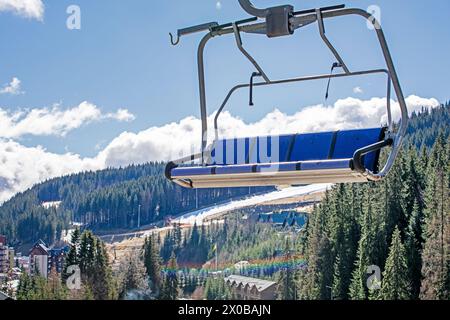 empty ski lift over ancient spruce trees. Active recreation Stock Photo