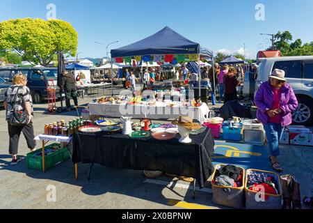 Motueka, Tasman/New Zealand - November 26, 2023: Motueka Sunday market looking across a bric-a-brac stall into the market. Stock Photo