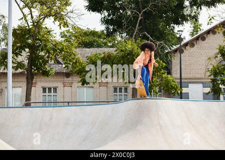 A man skillfully rides his skateboard up the side of a ramp, defying gravity with expert control and balance. Stock Photo