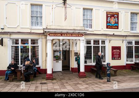 People sitting outside the Devon Arms public house in Teignmouth, Devon, UK. Colour photography. Stock Photo