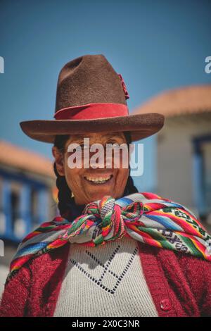 Cusco, Peru - March 2024. Peruvian woman wearing national clothing posing with llama near Cusco Peru. Stock Photo