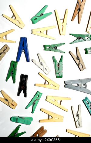Textural pattern created by multi-colored clothespins randomly scattered on a white background. Stock Photo