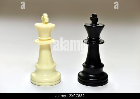 In the picture, on a white table, there are chess pieces kings, white and black. Stock Photo