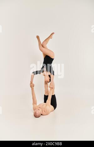Dancing women stand in a ballet stance, where the choreographer helps ...