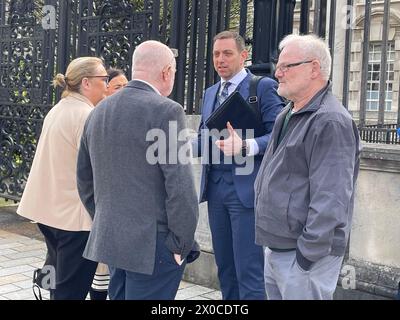 Solicitor Padraig O Muirigh (centre) with members of the families of Peter Ryan (known as Michael) and Tony Doris, two of the three men killed by the SAS during an incident at Coagh, Co Tyrone in June 1991 outside the Royal Court of Justice in Belfast where an inquest concluded the use of lethal force was justified but criticised the planning of the army operation. Picture date: Thursday April 11, 2024. Stock Photo