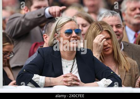 A racegoer watches the first race during the Randox Grand National 2024 Opening Day at Aintree Racecourse, Liverpool, United Kingdom, 11th April 2024  (Photo by Mark Cosgrove/News Images) Stock Photo