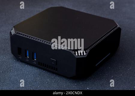 A small system unit of a personal computer. Compact black device. Stock Photo