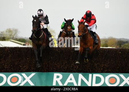 Liverpool, UK, 11th Apr, 2024. Gerri Colombe (Pink and black Cap), ridden by Jack Kennedy jumps the final fence alongside Ahoy Senor, ridden by Derek Fox, before going on to win the 14.55 William Hill Bowl Steeple Chase. UK. Photo Credit: Paul Blake/Alamy Sports News Stock Photo