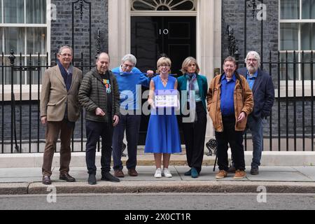 Hosts of The Movers and Shakers podcast (left-right) Sir Nicholas Mostyn, Rory Cellan-Jones, Paul Mayhew-Archer, Gillian Lacey-Solymar Mark Mardell and Jeremy Paxman with Parkinson's UK CEO Caroline Rassell (centre) mark World Parkinson's Day by handing in their 'Parky Charter' petition to 10 Downing Street, London, calling for more support for people with Parkinson's in the UK. Picture date: Thursday April 11, 2024. Stock Photo