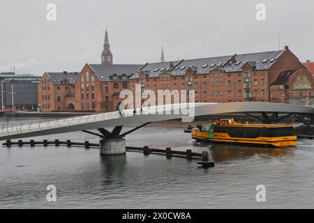 Yellow Boat bus passing under Lille Langebro bridge Copenhagen Denmark  April 2024 Stock Photo