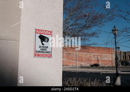 Warning 24 hour video surveillance no trespassing sign with CCTV camera symbol, in Lima Ohio USA Stock Photo