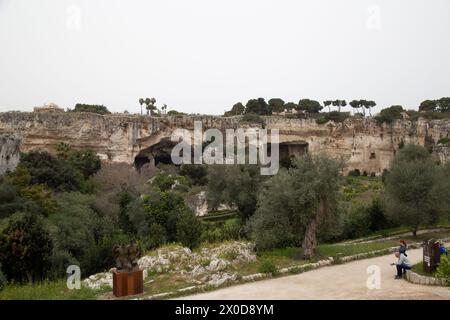 In the archeological park in Siracusa, the limestone quarries have become a tropical garden with fruit trees and art by Igor Mitoraj (among others) Stock Photo